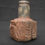 Chavín ritual stone bottle with a two-headed serpent engraving
